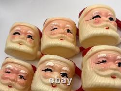 Set of 12 miniature made in Hong Kong Winking Santa plastic mugs Set of 12 miniature made in Hong Kong Winking Santa plastic mugs