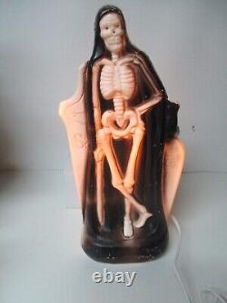 Vintage General Foam Halloween Blow Mold Light Skeleton in front of Tombstone