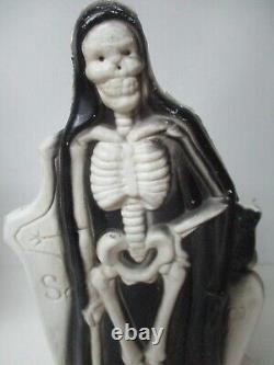 Vintage General Foam Halloween Blow Mold Light Skeleton in front of Tombstone