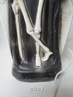 Vintage General Foam Halloween Blow Mold Light Skeleton in front of Tombstone